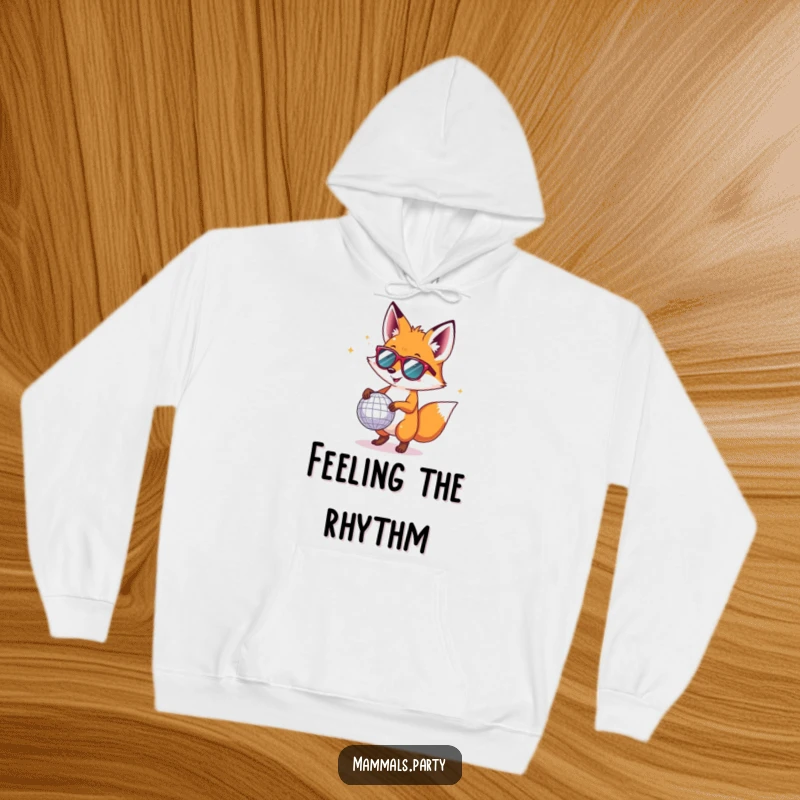Funny fox in tiny sunglasses, dancing under a disco ball, featured on a warm hoodie for maximum party vibes.